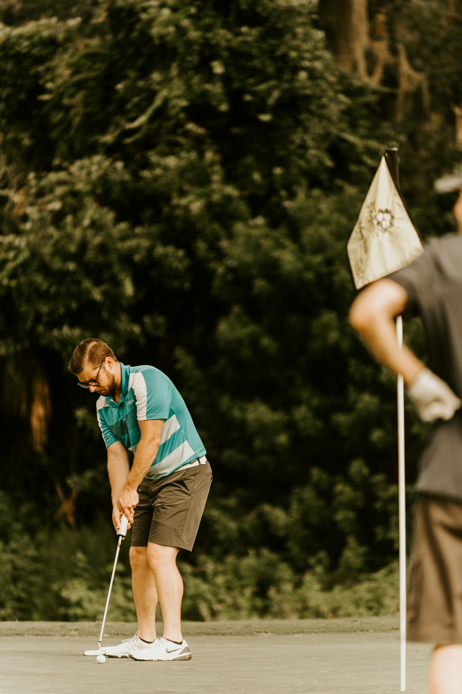 Golfer lining up a putt on a green