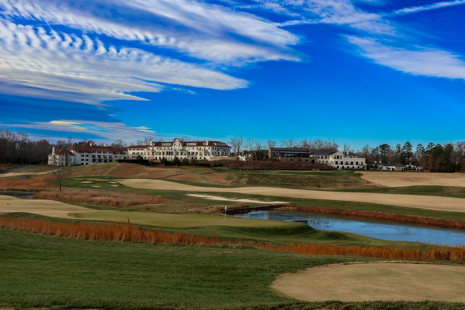 Dormant winter golf course with clubhouse in the background